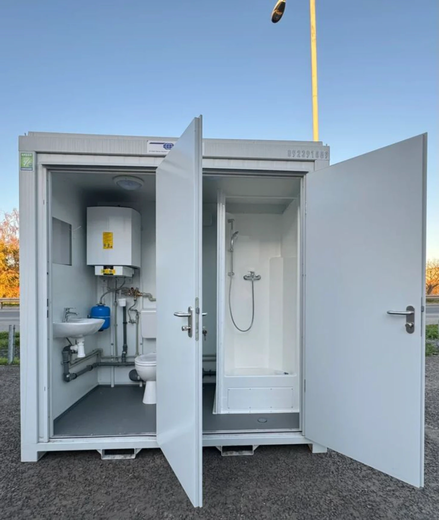 Porta potty rental staged on a graded construction site in Richmond, VA with excavation equipment active nearby